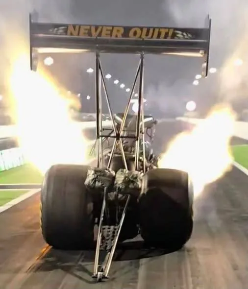 NEVER QUIT on the wing, with header flames at night