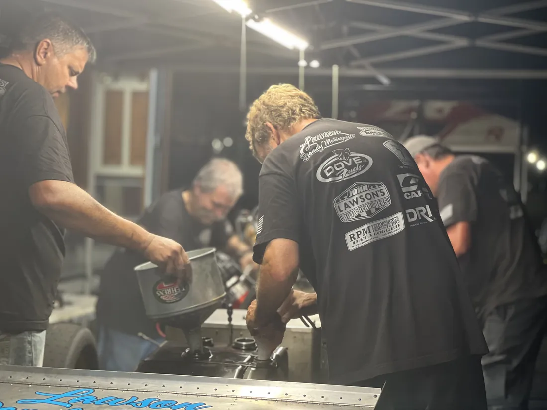 The Dove Motorsports crew working on the engine in the pit