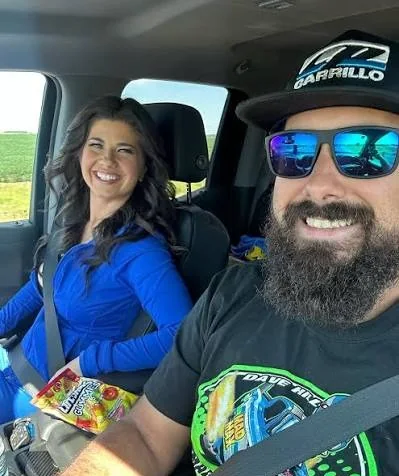 Ryan Hill and Shannon Hill smiling on a road trip in their truck